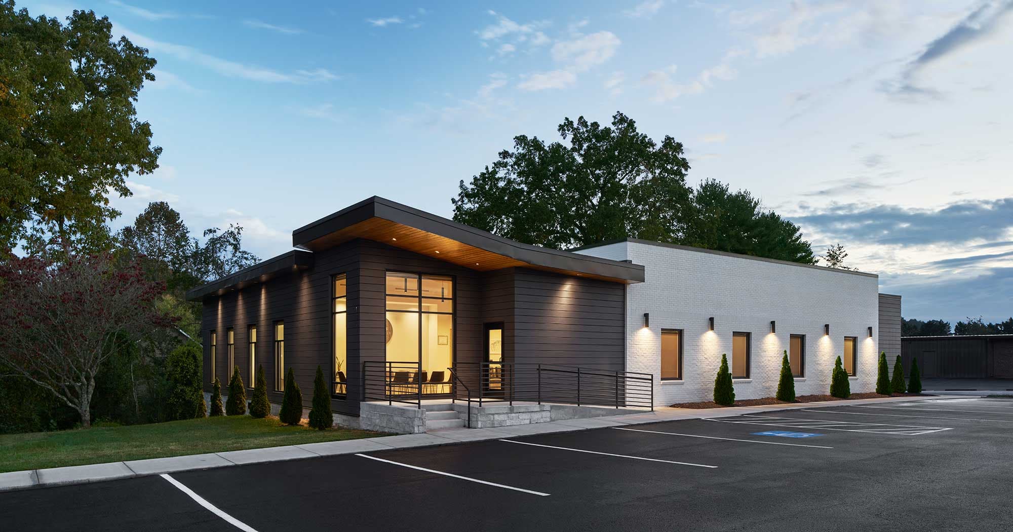 The Winchester Family Dentistry building at dusk, its lobby windows lit.